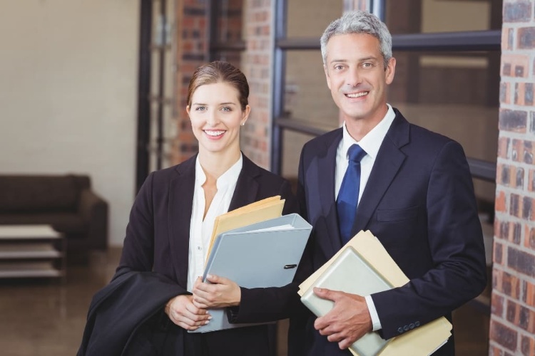 Lawyers Smiling And Holding Legal Docs